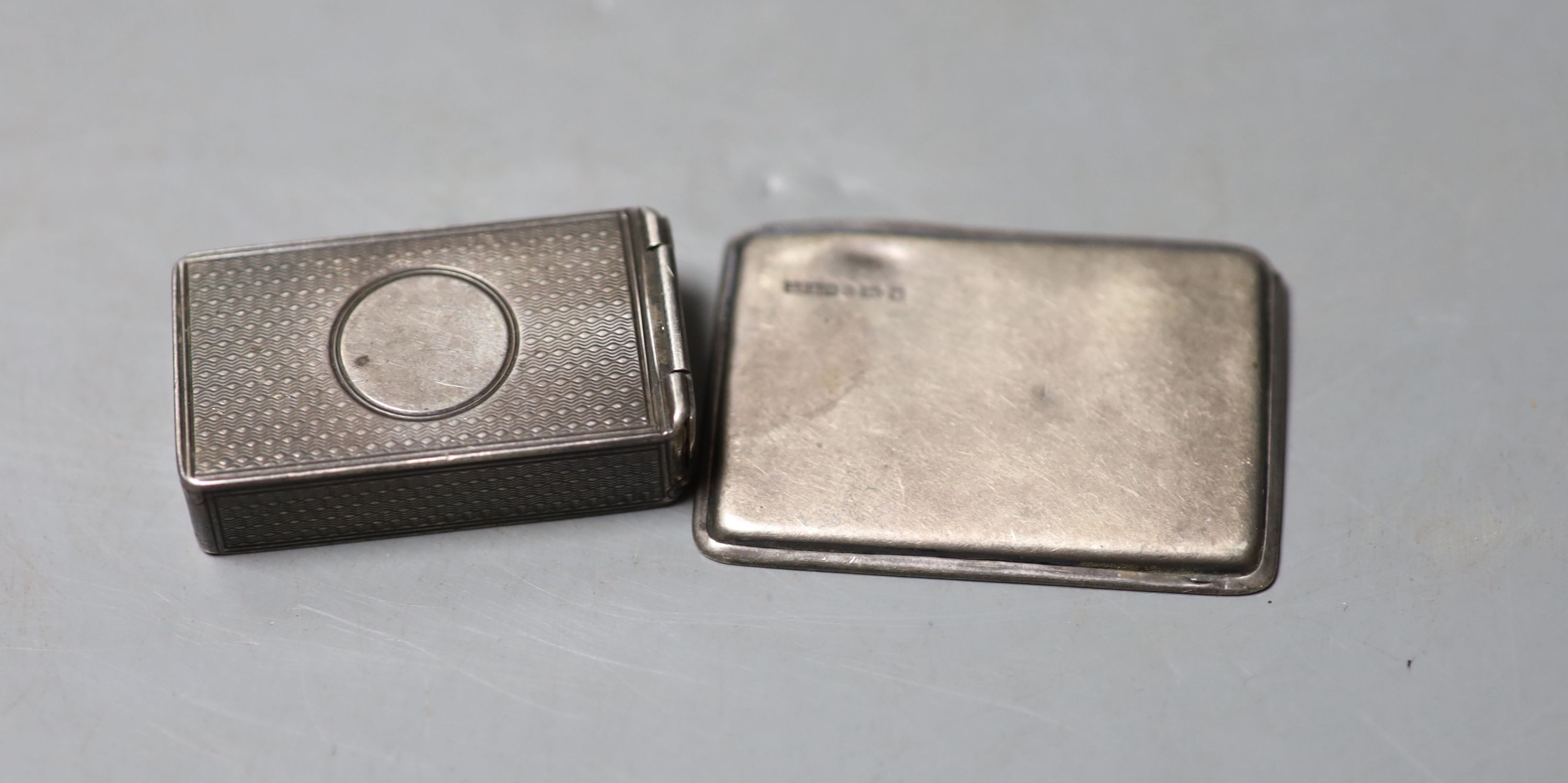 A Victorian engine turned silver vesta case, George Adams, London, 1879, 45mm and a later silver stamp case, 52mm.